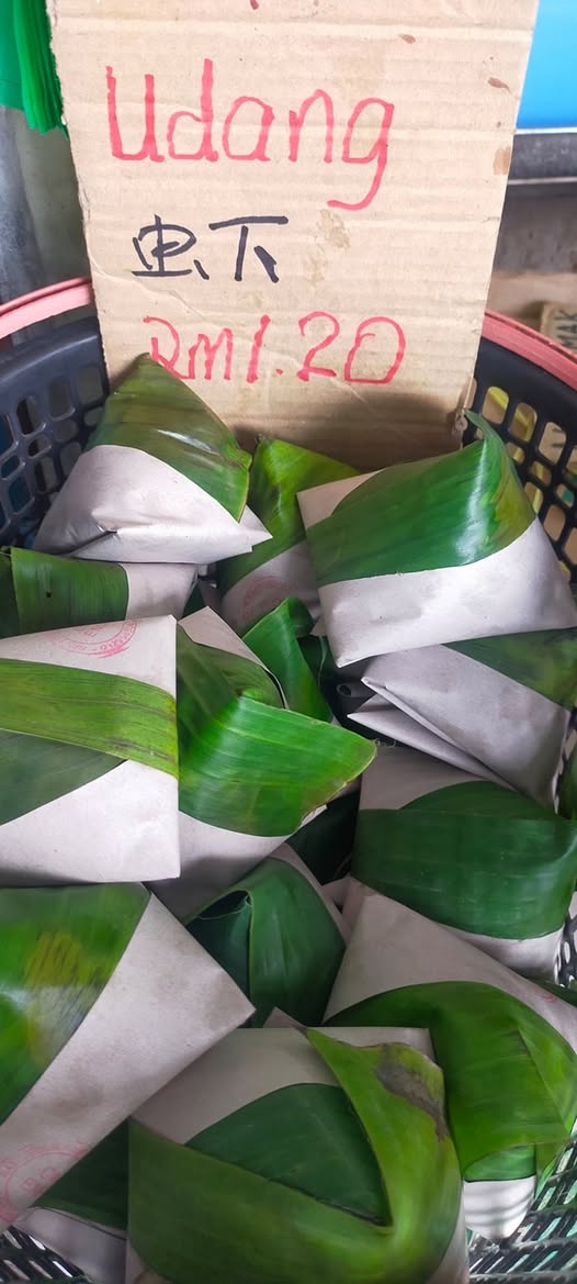 Nasi lemak bungkus wrapped in banana leaf and paper