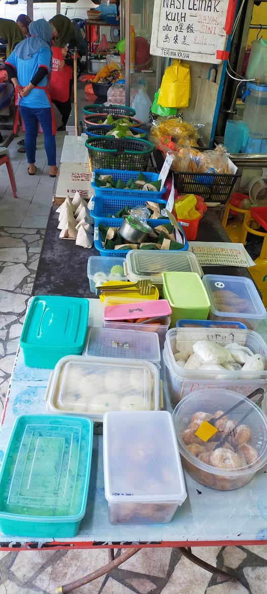 The nasi lemak and kuih table inside the shop
